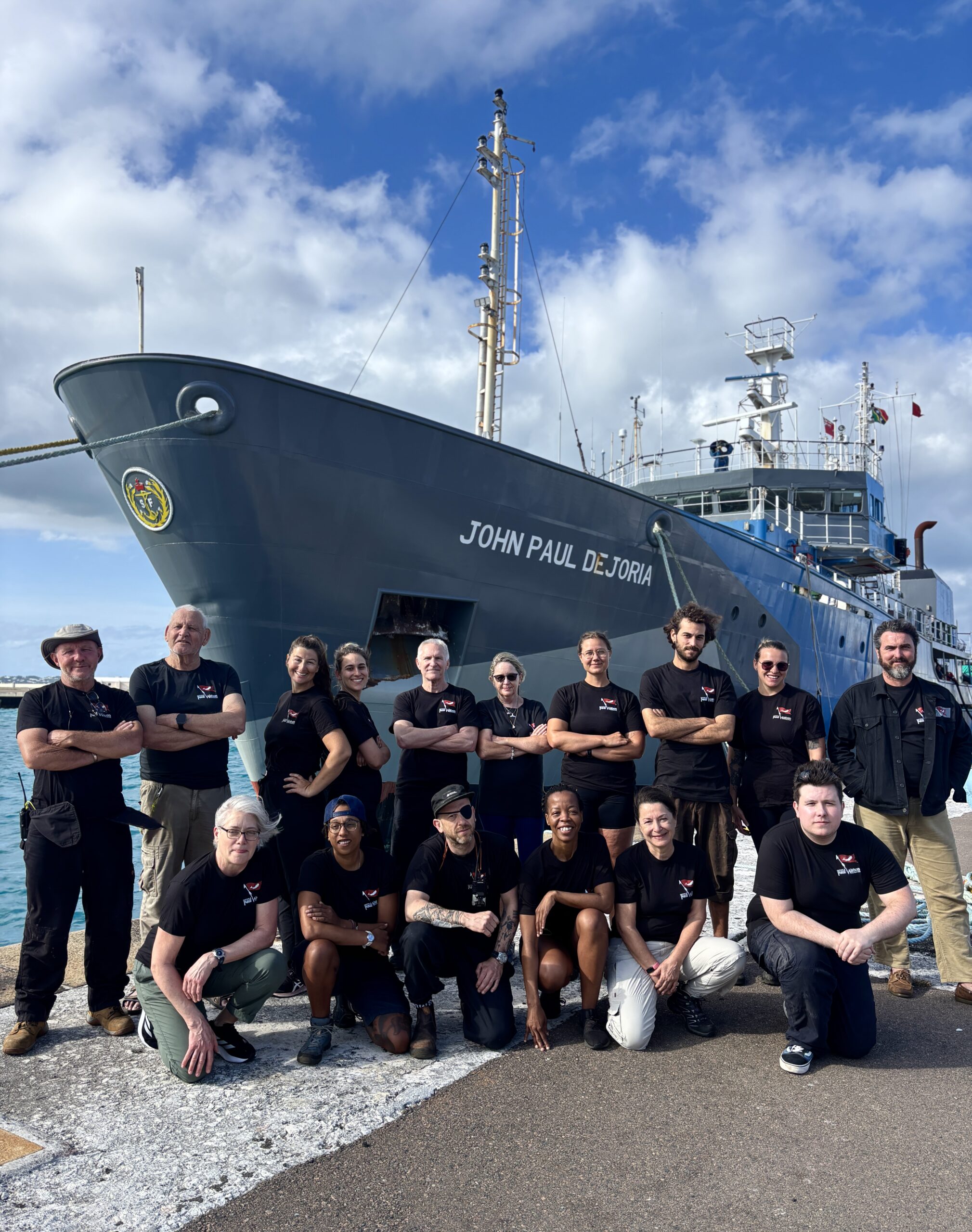 Captain Paul Watson Foundation crew in front of the John Paul DeJoria ship